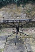 A pierced metal garden table on quadruped base. H.90 Dia.120cm