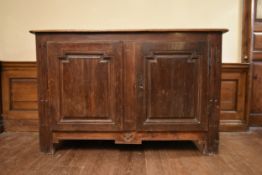 An 18th century French fruitwood cabinet with fielded panel lozenge shaped doors enclosing shelved