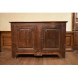 An 18th century French fruitwood cabinet with fielded panel lozenge shaped doors enclosing shelved