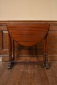 A 19th century mahogany drop flap Sutherland table on turned tapering supports. H.69 W.82 (extended)