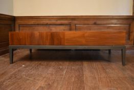 A contemporary teak coffee table fitted with end drawer on metal base with square tapering supports.