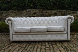 A three seater Chesterfield sofa in deep buttoned and studded leather upholstery. H.70 W.180 D.80cm