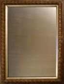 A 19th century gilt framed wall mirror with original plate in floral gesso decorated frame within
