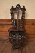 A 19th century Italian Renaissance Revival fruitwood hall chair with all over figural, fruit and