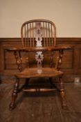 A 19th century yew Windsor armchair with pierced central splat and elm saddle seat on turned