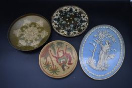 A set of four Oriental brass decorative wall plates. Dia.31cm largest (4)