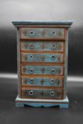 An Indian jewellery chest in the form of a painted six drawer tallboy with gilt Fleur de Lys