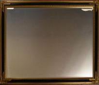 A wall mirror with bevelled plate in gilt and ebonised floral frame. H.105 W.137cm