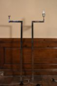 A pair of contemporary chrome standard lamps with articulated arms standing on platform bases. H.109
