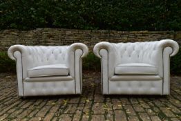 A pair of Chesterfield armchairs in deep buttoned and studded leather upholstery. H.70 W.103 D.