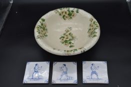 Three signed Paul Bommer Delft tiles and an ironstone bowl with floral decoration. H.13 W.13cm (