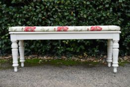A late 19th century painted window seat in floral upholstery. H.52 W.122 D.34cm