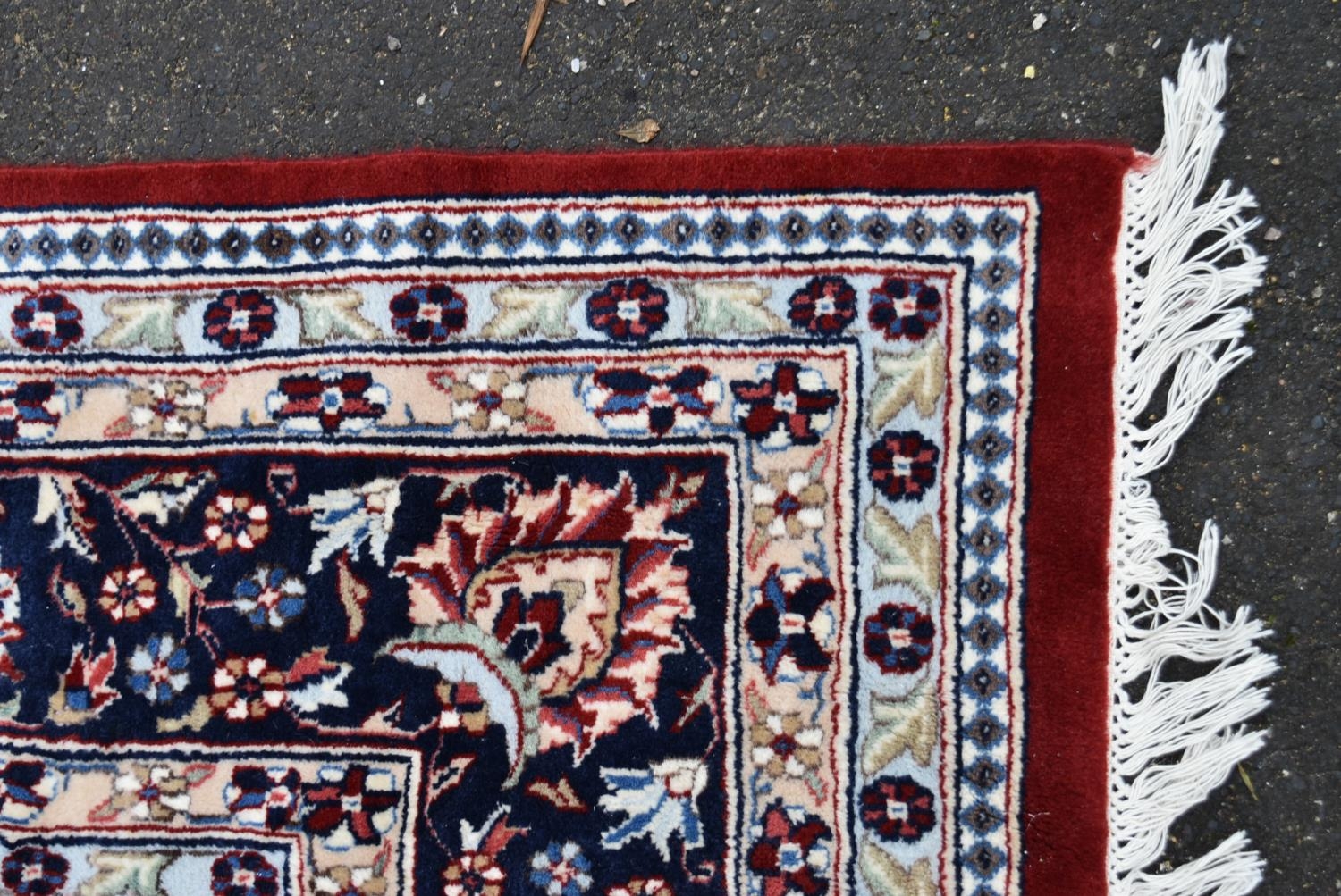 A Persian Keshan carpet with floral central medallion on burgundy ground within foliate spandrels - Image 2 of 3