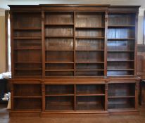 A late 19th century oak breakfront library bookcase with architectural pilasters flanking open