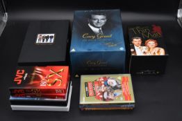 The boxed Cary Grant movie collection along with other dvd's. H.28 W.18 D.13cm (10)