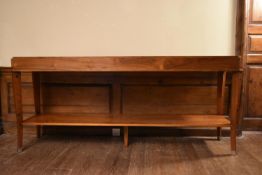 A contemporary teak console table on slender sabre supports united by undertier. H.88 W.200 D.45cm