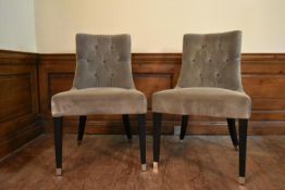 A pair of contemporary nursing chairs in buttoned velour upholstery on square tapering ebonised