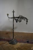 A vintage adjustable wrought iron desk lamp with scrolling foliate detail. H.67 W.30cm
