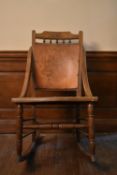 A late 19th century walnut rocking chair with floral pokerwork decorated back and seat. H.90 W.50