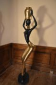 A mid century modern brass and copper African lady sculpture in the style of Karl Hagenauer. H.165
