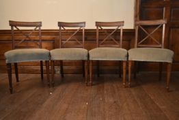 A set of four 19th century mahogany bar back dining chairs with X shaped back splats raised on