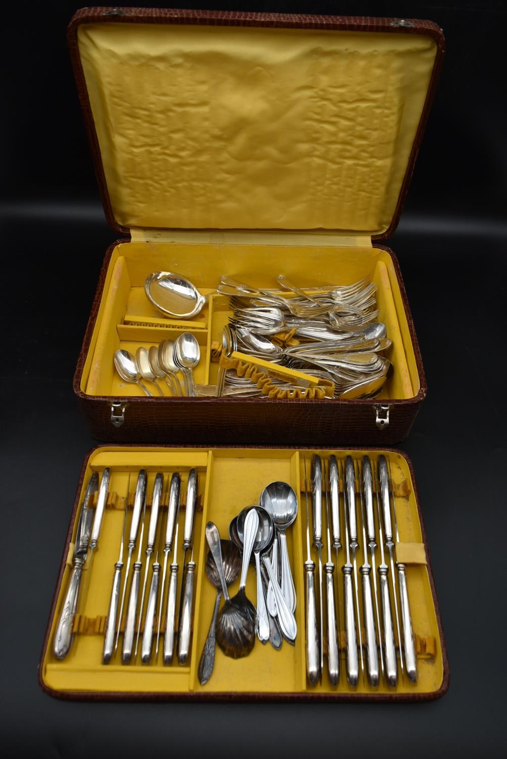 A 1920's silver plated cutlery set in a crocodile skin case fitted with lift out tray, including