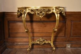 A Rococo style gilt console table with shaped marble top. H.87 W.92 D.30cm