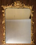 An early 19th century carved giltwood overmantel mirror with original plate in naturalistic