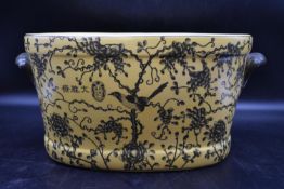A Chinese porcelain footbath with hand painted foliate design, stamped to base. H.23 W.48 D.30cm