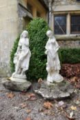 A pair of composite white painted garden statues of two young female figures. H.78cm