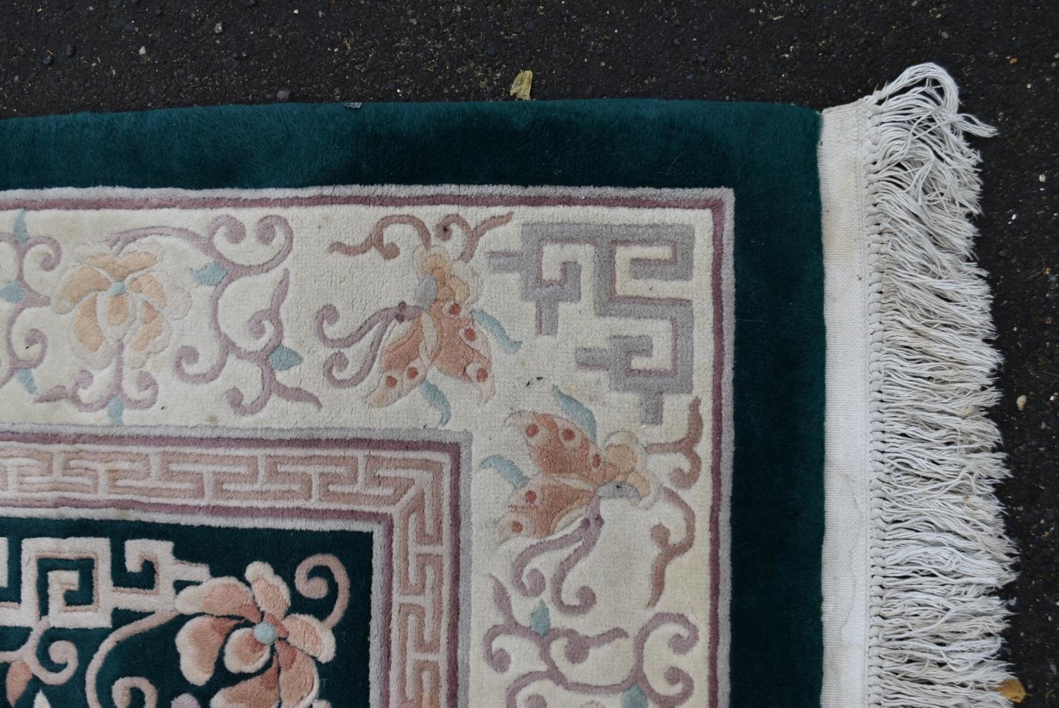 A Chinese carpet with emerald ground, central medallion within a cream foliate border. L.300 W.183cm - Image 2 of 3