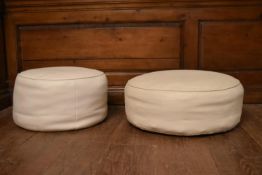 A vintage footstool in piped leather upholstery along with a similar footstool. H.25 Dia.60cm (