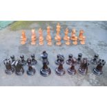 A carved wooden and varnished giant garden chess set. H.60cm (queen) H.30cm (Pawns)