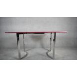 A vintage Calligaris console table with foldover top opening to a dining table on chrome framed