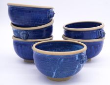 Six Fired Earth blue glazed stoneware bowls with mask handles. D.14cm