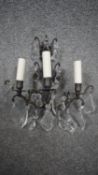 A bronze effect three branch wall sconce with cut glass drops. H.41 W.34