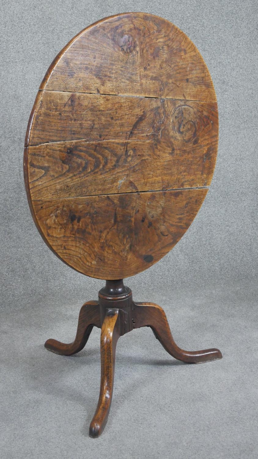A Georgian oak tilt top table on baluster pedestal tripod supports. H.75cm (top in need of some - Image 2 of 4