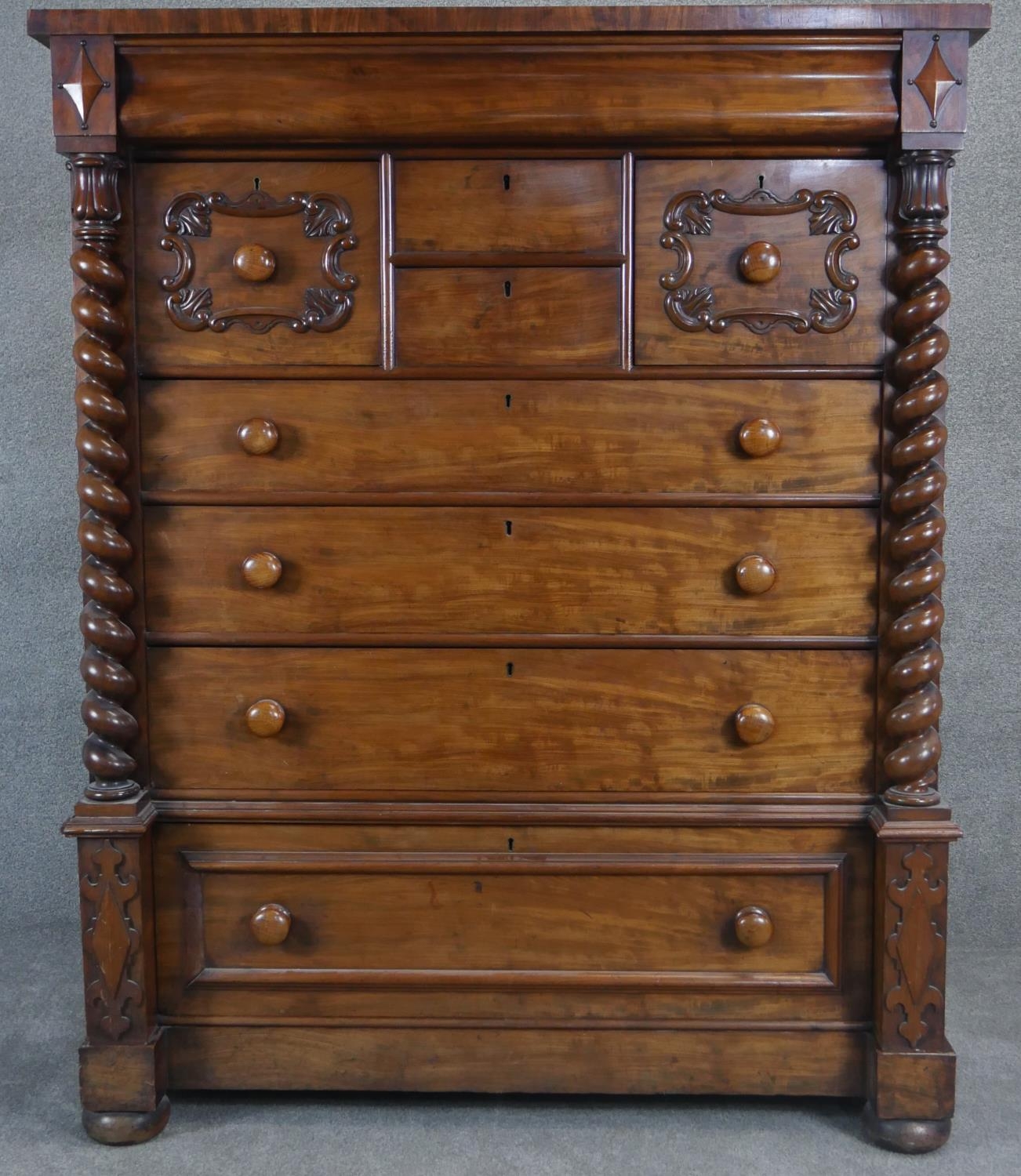 A 19th century mahogany Scottish chest of drawers with and arrangement of drawers flanked by