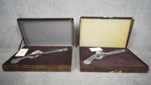 Two boxed crystal duelling pistols by Royales De Champagne. H.13 W.40