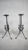 A pair of wrought iron candle stands on tripod griffin head supports. H.75 W.36 D.35 (one leg