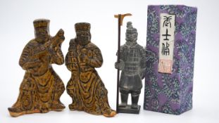 A pair of Tang style salt glaze ceramic tomb attendants, one playing an instrument along with a