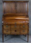 A 19th century Continental mahogany and ebony and satinwood inlaid cylinder bureau cabinet with