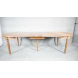 A French Provincial style cherrywood extending dining table with three extra leaves on turned