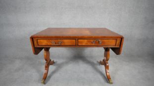 An Edwards and Roberts Regency style satinwood crossbanded sofa table with all over hand painted