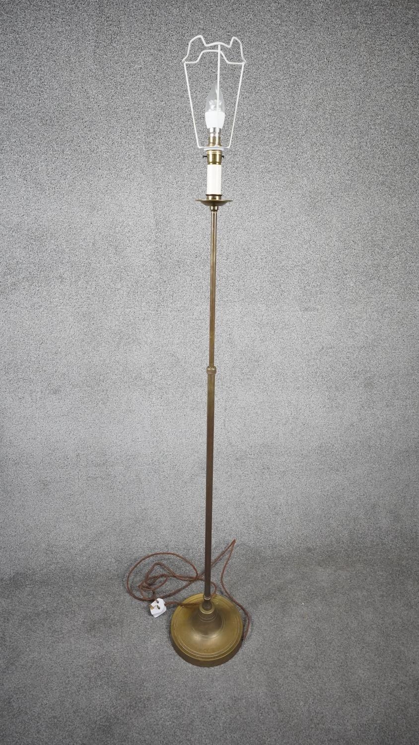 A vintage solid brass weighted base height adjustable standard lamp with silk wrapped cord. H.151