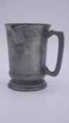 A 19th century handled pewter spouted pint measure by Benjamin Grimes of Whitechapel London.