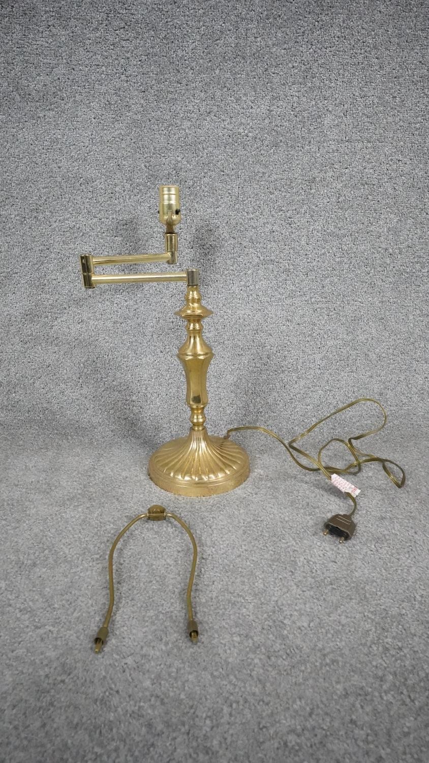 A brass desk lamp with adjustable articulated arm. H.44