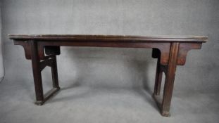 A 19th century Chinese teak altar table on carved and shaped platform supports. H.90 W.214 D.47