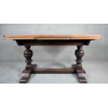 A mid century oak Jacobean style draw leaf dining table on baluster turned stretchered supports. H.