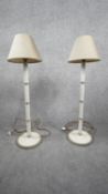A pair of white painted wooden table lamps with ridged detailing and cream silk shades. H.81
